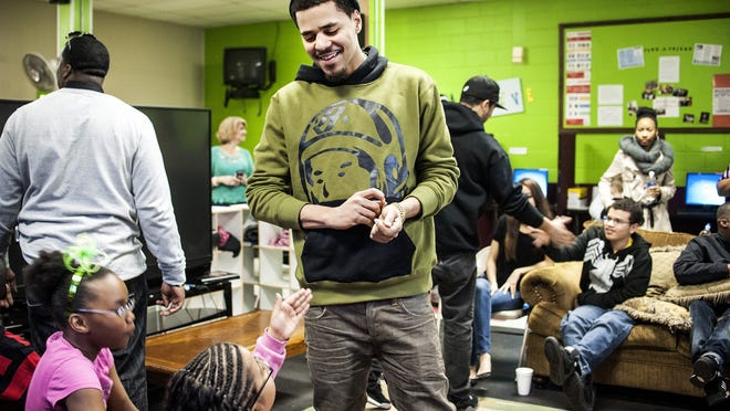 J. Cole walks around and greets every child in the Find-A-Friend program at Fayetteville Urban Ministry on Friday, March 8, 2013.