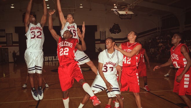 Terry Sanford's Jermaine Cole (15) goes up for a rebound with a teammate during a game Seventy-First High School on Feb. 24, 2003, in Fayetteville, N.C.